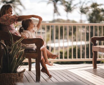 happy mother playing with cute daughter