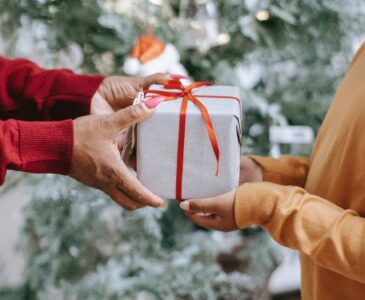 black woman giving gift to kid