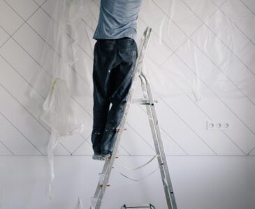 housepainter on ladder working in room