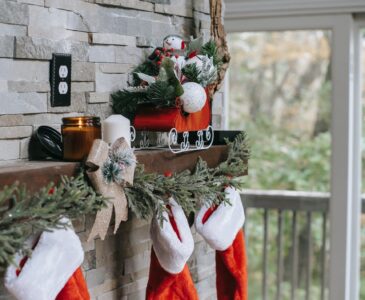 xmas decorations on brick wall above fireplace