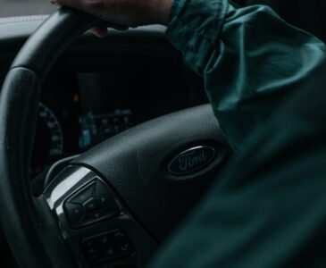 person in green long sleeve shirt driving car