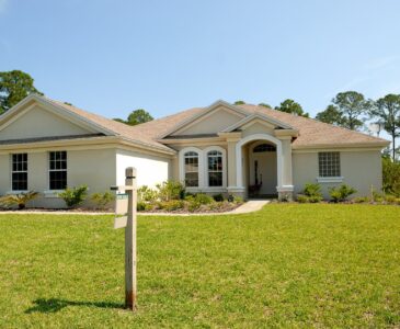 white and brown concrete bungalow under clear blue sky
