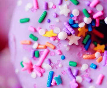 pink doughnut with colorful sprinkles